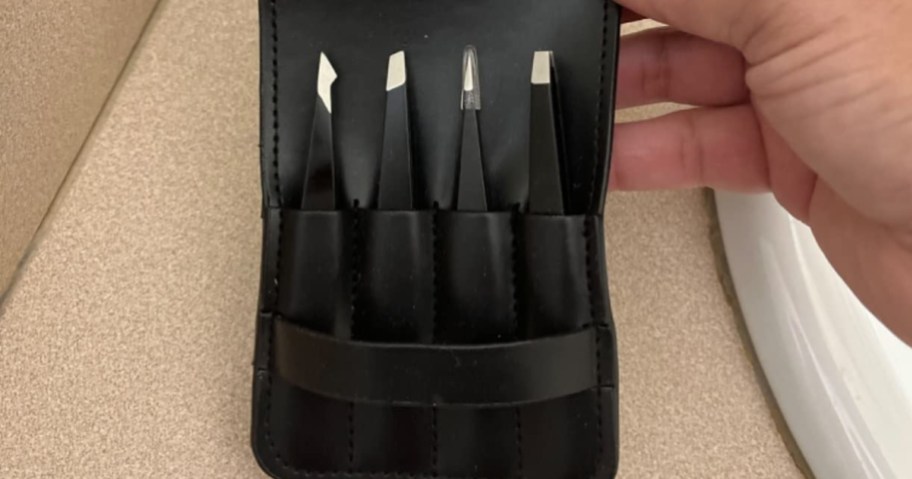 pefei 4-piece tweezer set inside black travel case in bathroom