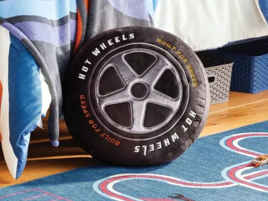 Pillowfort Hot Wheels Retro Soft Tire Throw Pillow w/ Car Storage next to bed