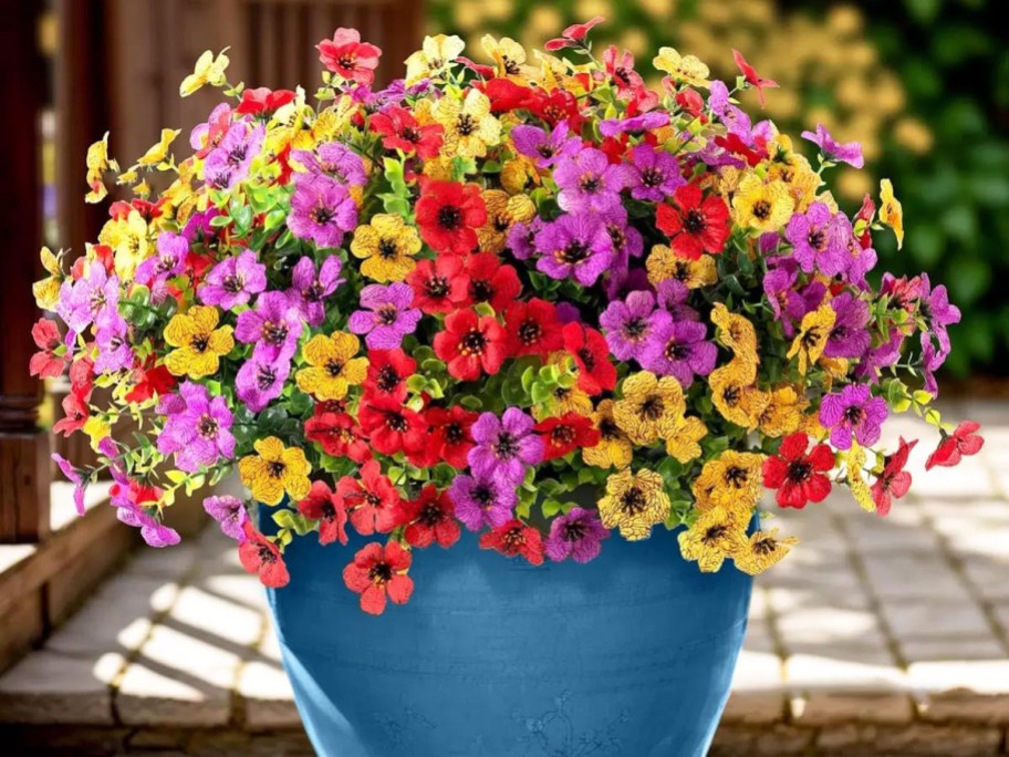 colorful artificial flowers in a blue pot