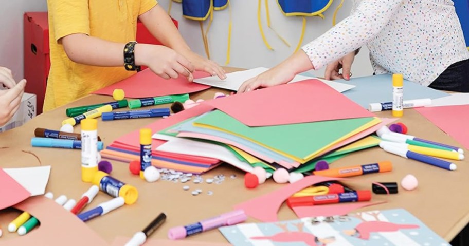 construction paper and craft supplies on a table