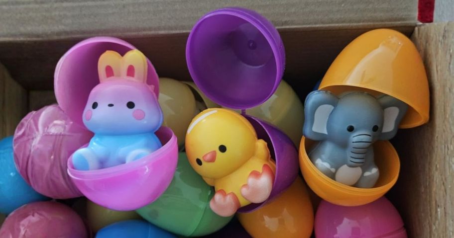 three easter eggs open in box with squishies in them