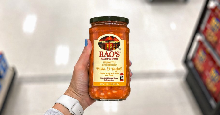 hand holding a jar of Rao's Pasta Fagioli Soup in store