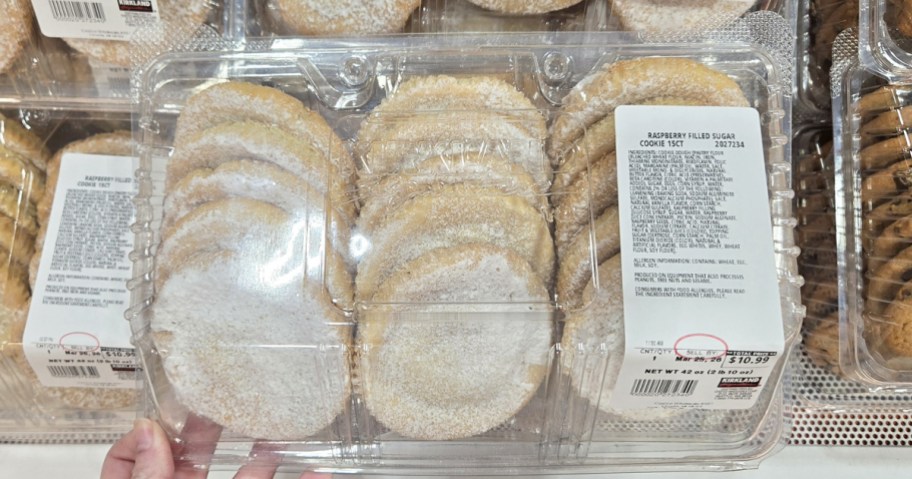 hand holding a container of Raspberry Filled Sugar Cookies in store