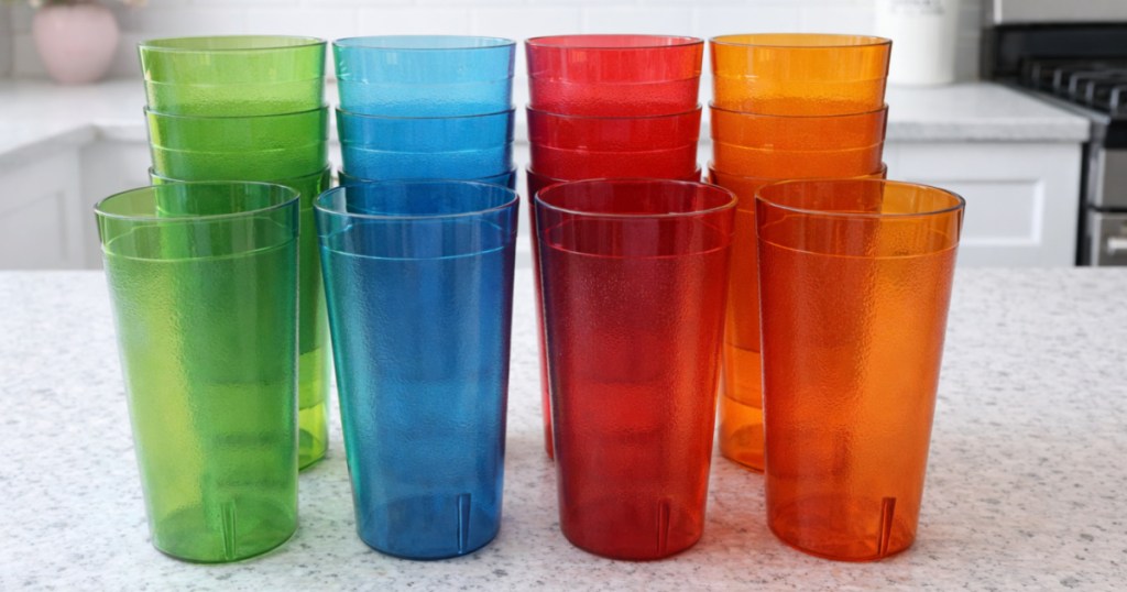 Rainbow colored retro plastic tumblers on white kitchen counter