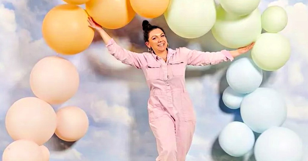 Woman holding reusable balloon arch in different colors