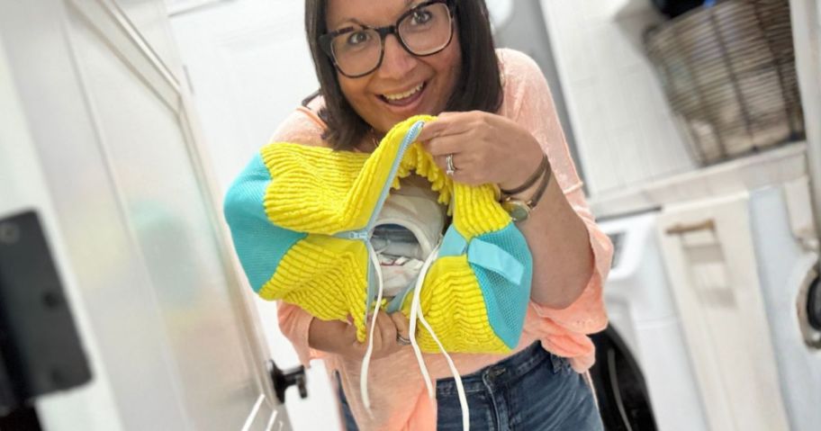 lina holding yellow Washing Machine Shoe with shoes in it