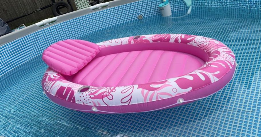pink Inflatable Tanning Pool floating on water in pool