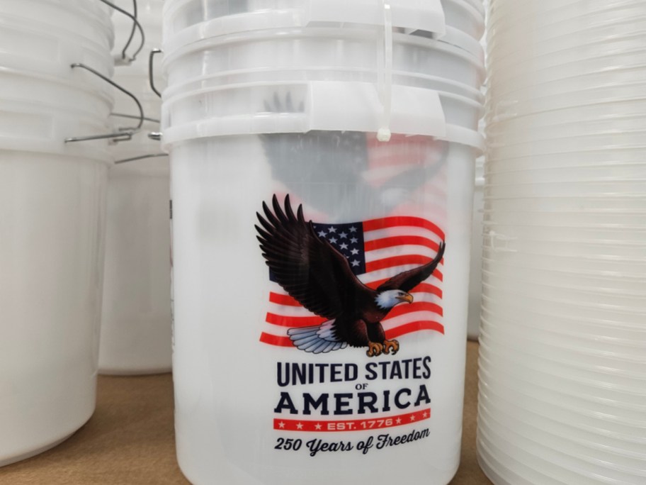 A bucket with an American flag design and an eagle, labeled "United States of America" and "250 Years of Freedom."