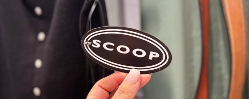hand holding up a scoop clothing tag