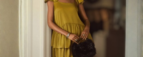 woman wearing Scoop Women's Satin Bow Mini Dress leaning on door frame holding clutch