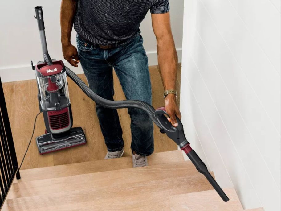 person using Shark Navigator Swivel Pro Vacuum on stairs