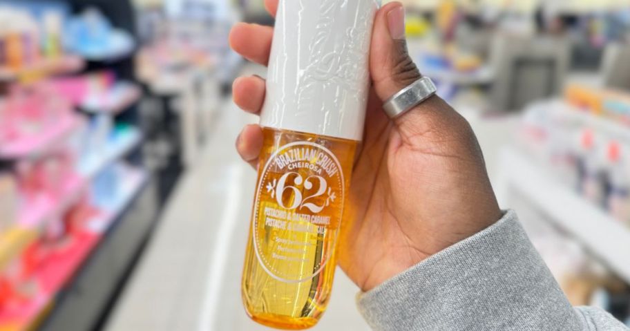 hand holding Sol de Janeiro Cheirosa 62 Bum Bum Hair & Body Perfume Mist 8.1oz in store