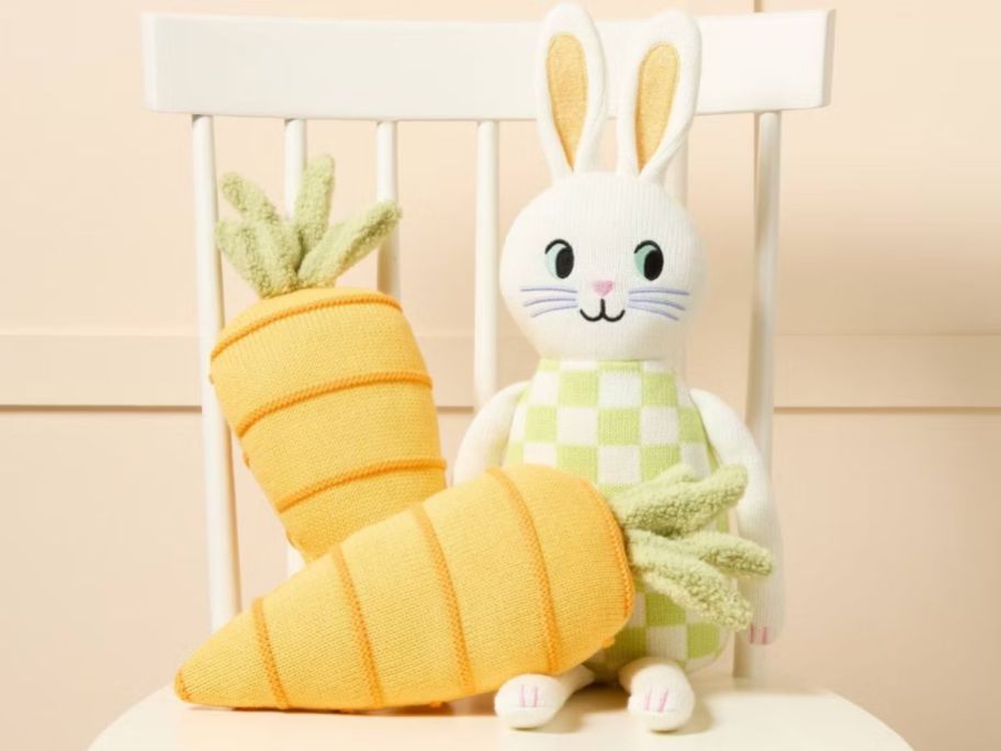 Spritz carrot pillows and a bunny plush on a chair
