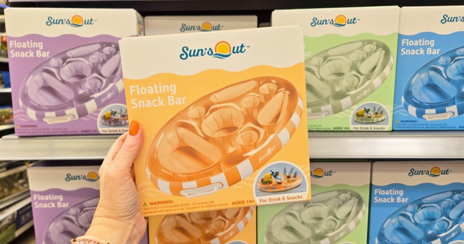 woman's hand holding up an orange inflatable snack bar 