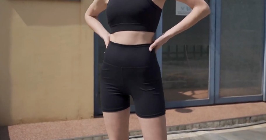 woman wearing Syrinx bike shorts in black with black sports bra