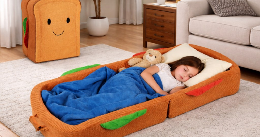 Toddler sleeping in sandwich style bed on living room floor