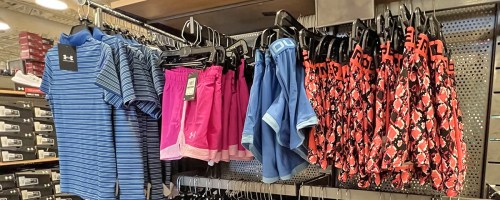 under armour shorts and polo on display in store