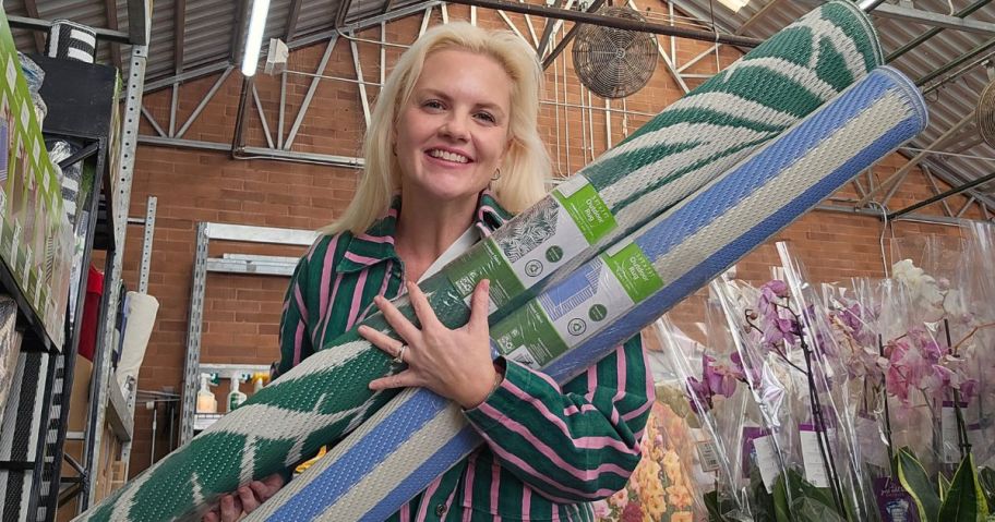 Woman holding Walmart Area Rugs