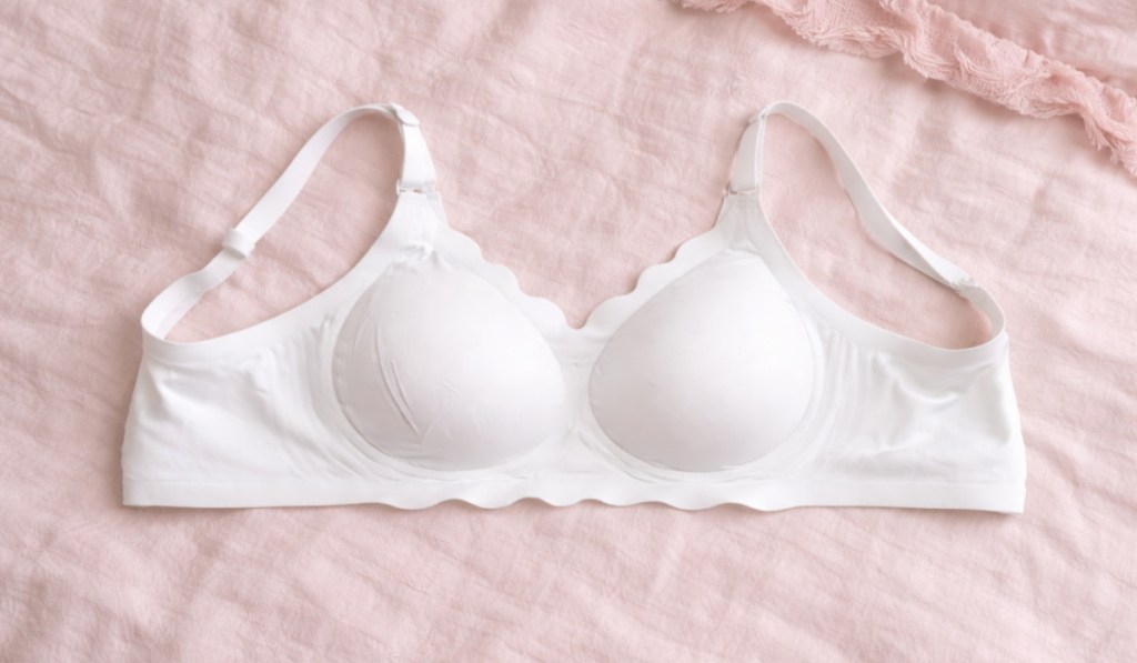 White jelly bra laying on pink comforter
