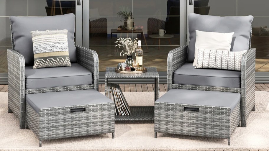 grey wicker chairs with matching ottomans and table