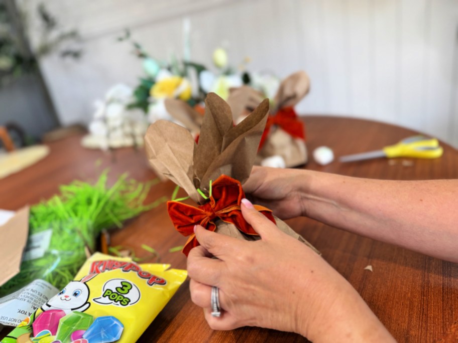 adding a bow to a bunny bag