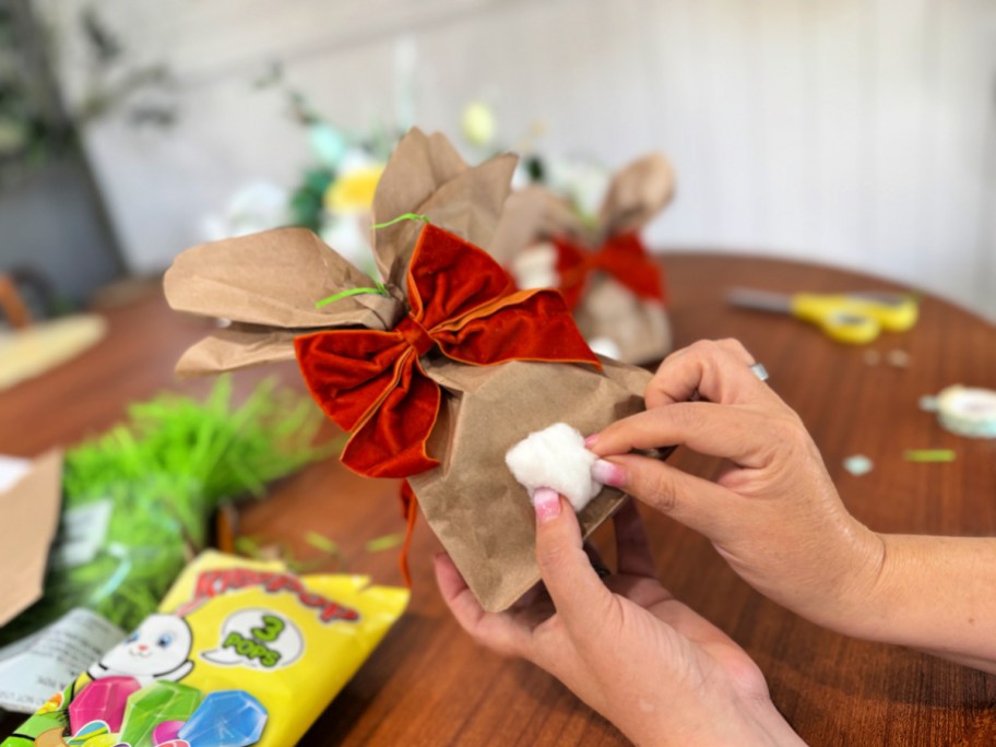 adding a cotton ball tail to bunny bag