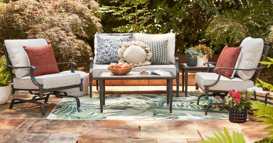 patio conversation set with light grey cushions and coffee table