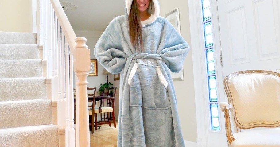 girl wearing gray and white wearable blanket 