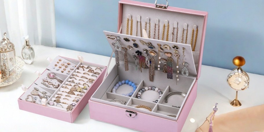 pink jewelry box full of jewelry on counter