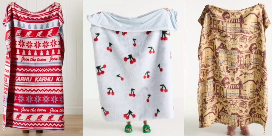 Three blankets displayed vertically: a red-and-white Nordic pattern, a blue with cherry prints, and a vintage map design.