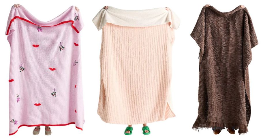 three people holding anthropologie blankets