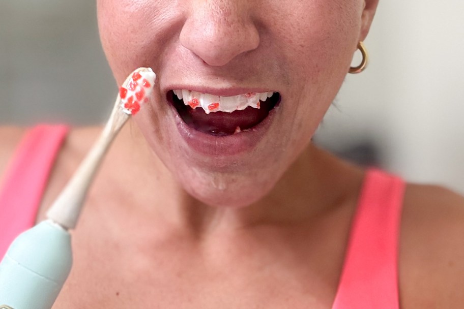 womans mouth open with toothpaste and pop rocks next to toothbrush