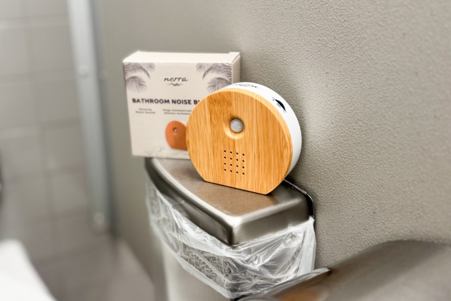 bamboo round sound machine on public bathroom trash can