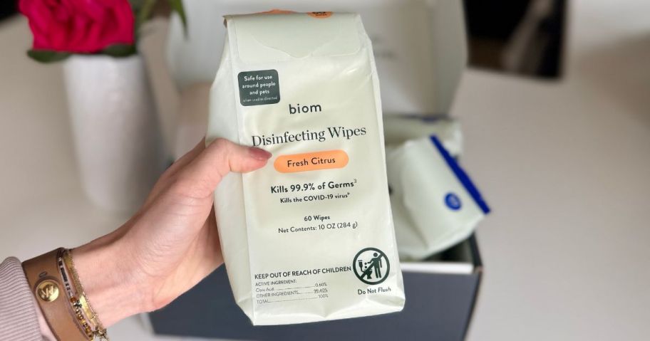 Biom Disinfecting Wipes 60-Count package in hand