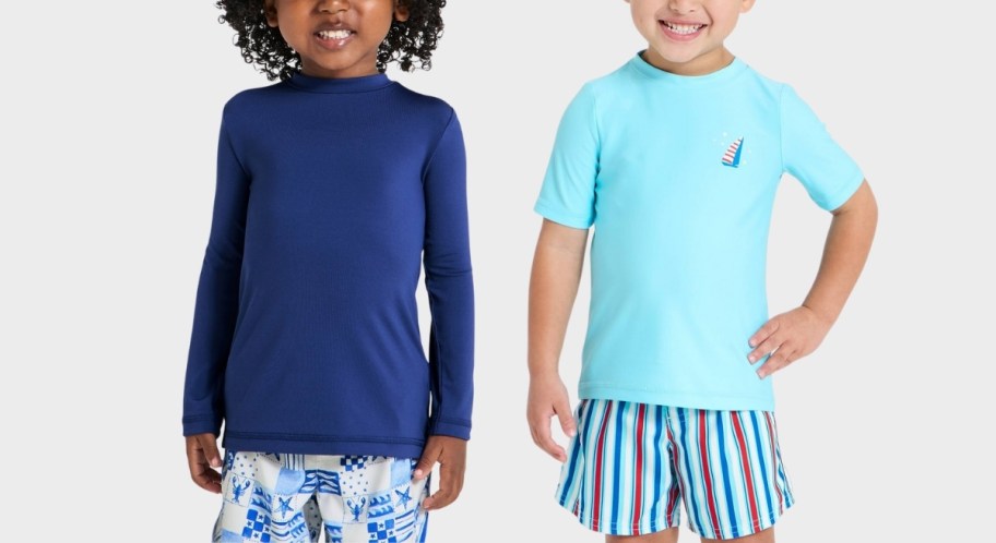 two toddler boys in rash guards and swim trunks