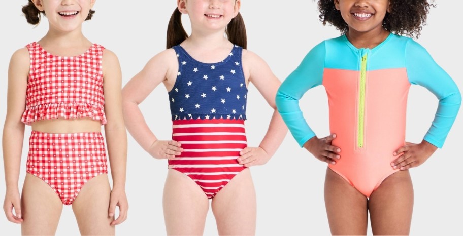 three toddler girls in different styles of swimsuits