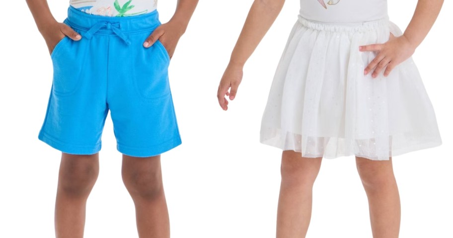 lower half of a boy wearing shorts and lower half of a girl wearing a skirt