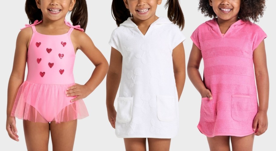 toddler girl in a tutu swimsuit and two girls in swim coverups
