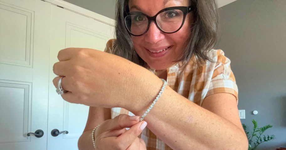 woman showing off a tennis bracelet on her wrist