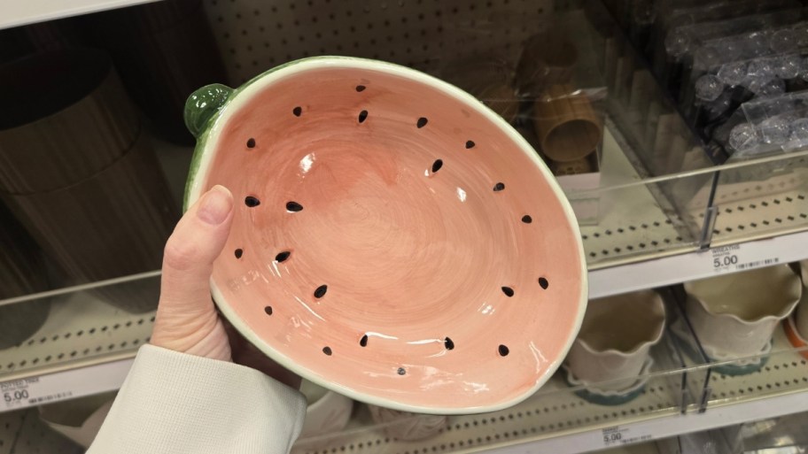 Woman's hands holding ceramic watermelon serving bowl
