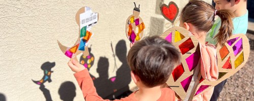 kids holding up crafts