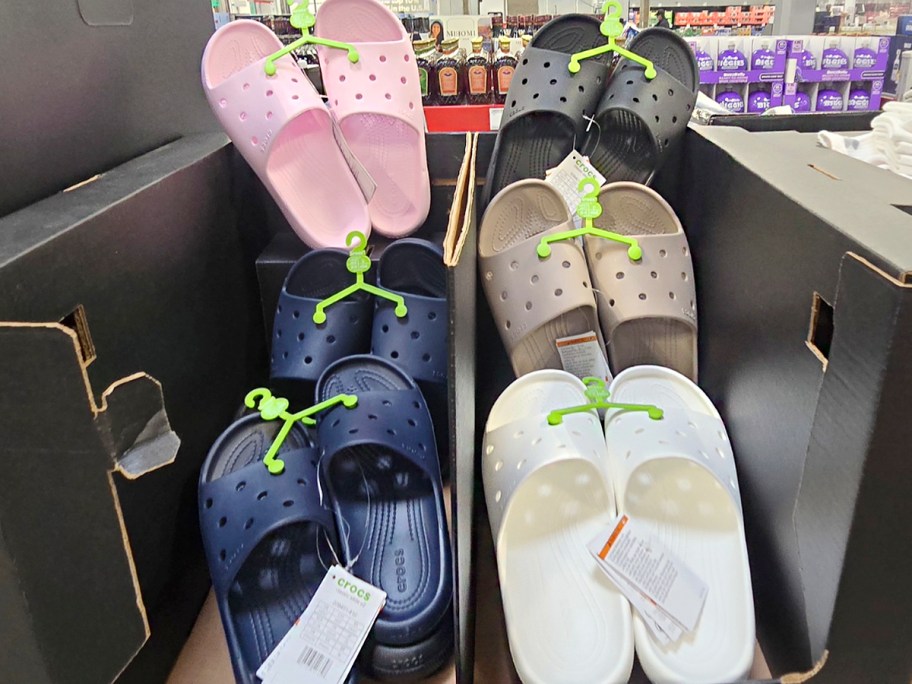 pink, blue, white, and brown crocs slides 