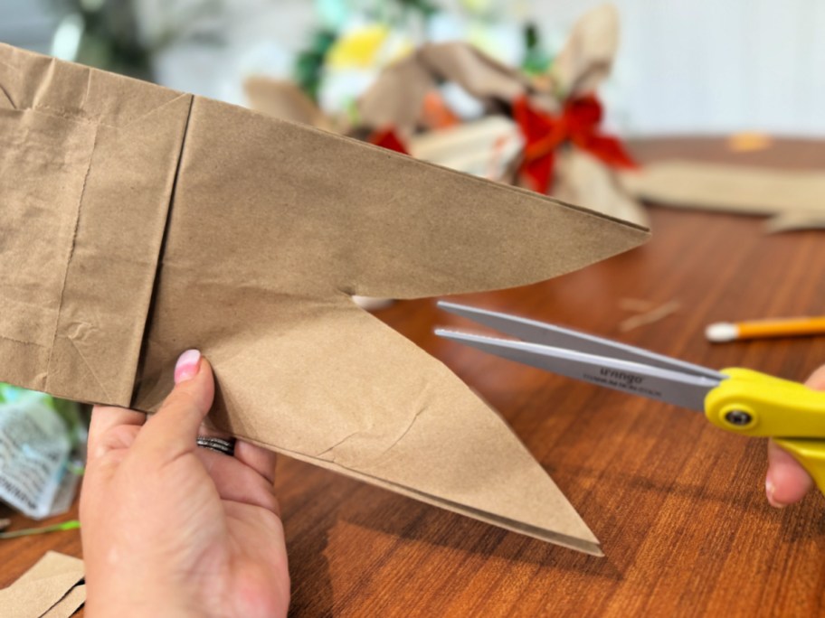 cutting the paper bag with scissors
