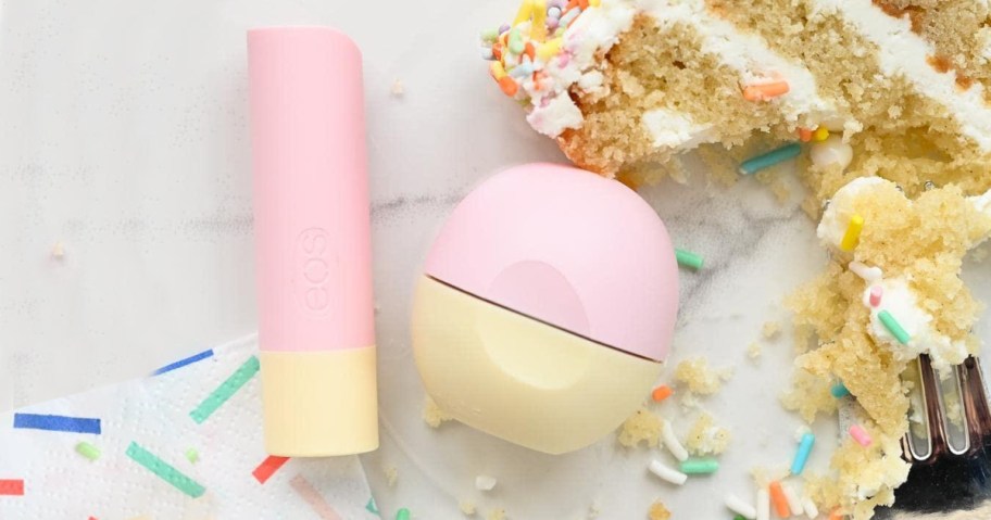 eos Birthday Cake Lip Balms on table near slice of cake