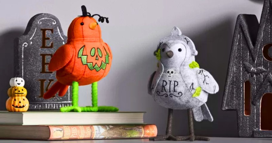 decorative Halloween birds that look like a jack-o-lantern and tombstone 