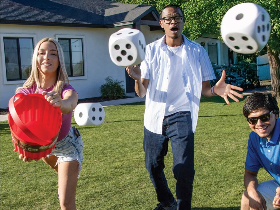 teens playing with large dice from a giant Yahtzee game