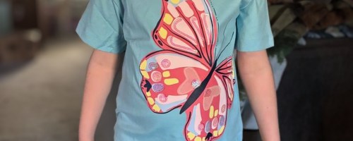 a girl in a blue butterfly tee