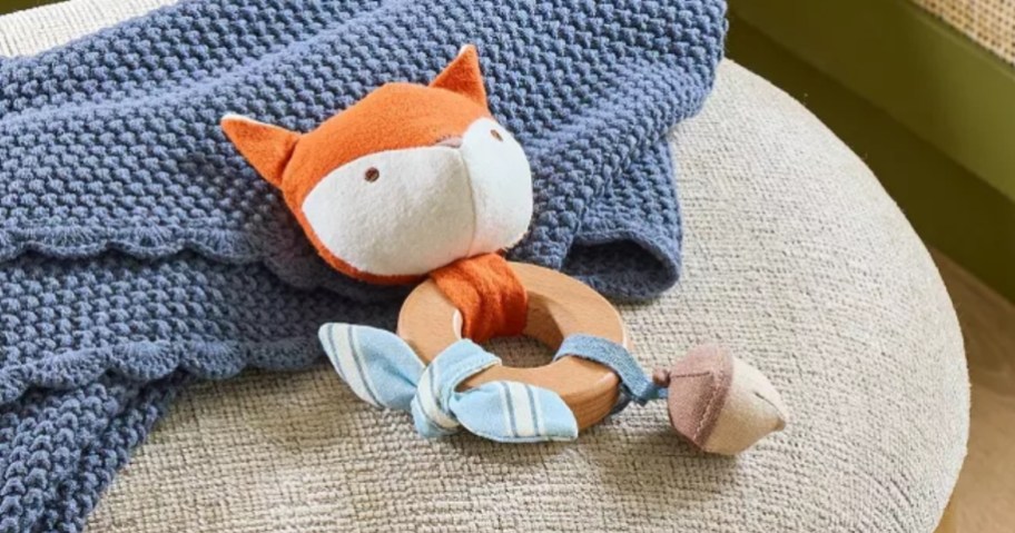 a wooden and plush fox baby toy
