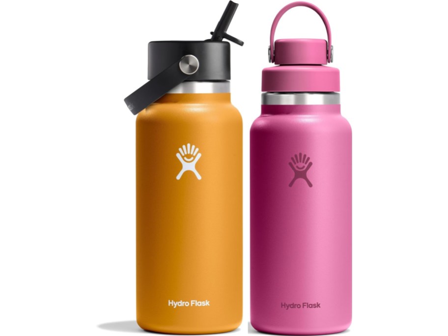 Two Hydro Flask bottles are side by side: one orange with a black lid and straw, the other pink with a matching lid handle. Both feature the logo.