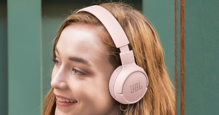 woman wearing pink JBL headphones